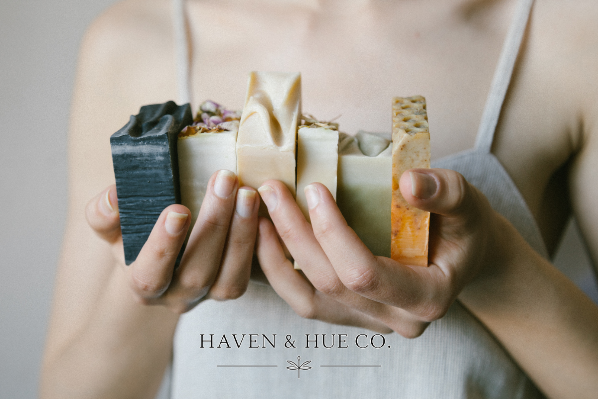 Aesthetic stack of natural, handmade body soap bars in neutral colors, crafted for sensitive skin and presented as part of a luxury collection.